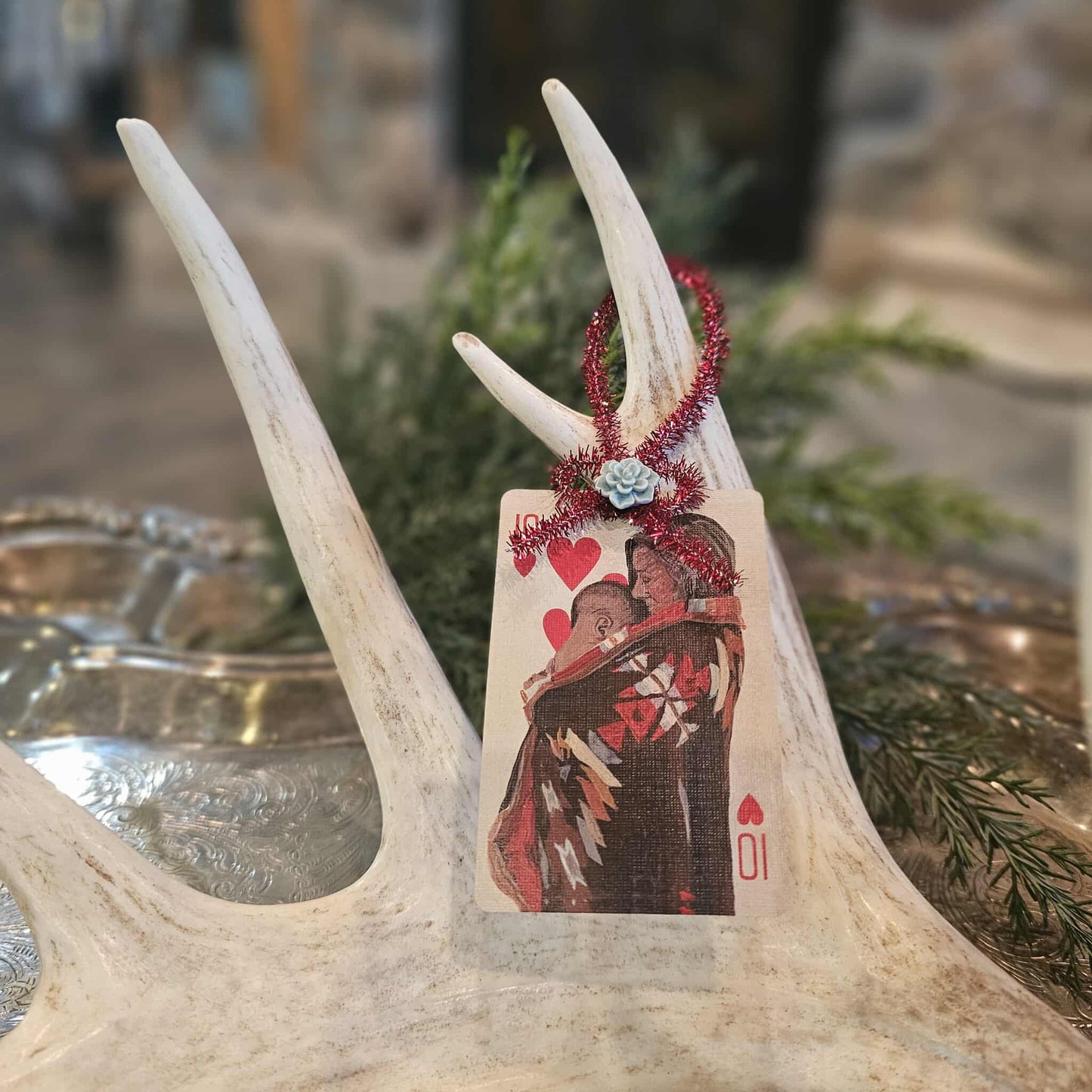 Vintage style Native American woman and child playing card Christmas ornament hanging on an antler