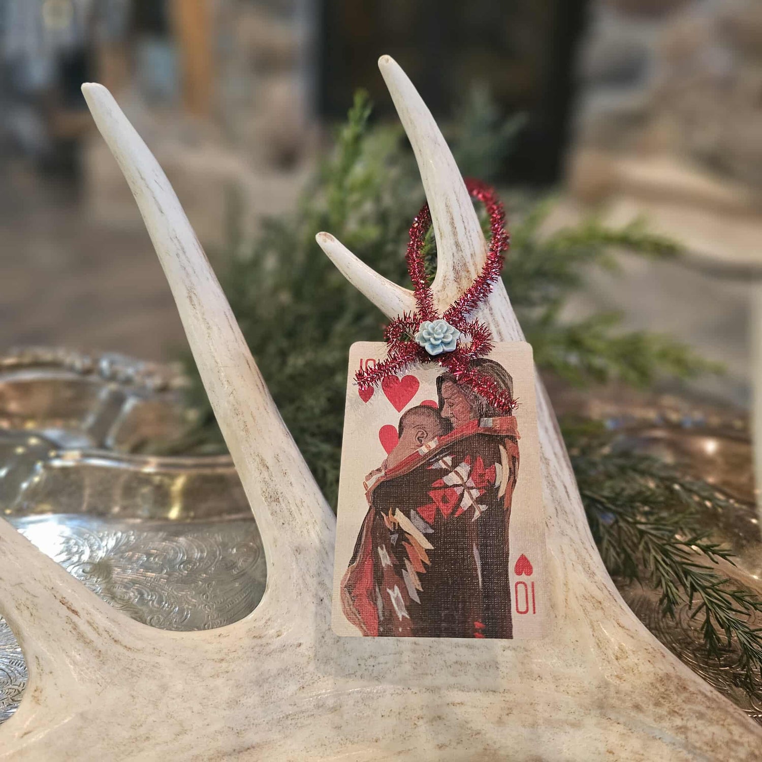 Vintage style Native American woman and child playing card Christmas ornament hanging on an antler