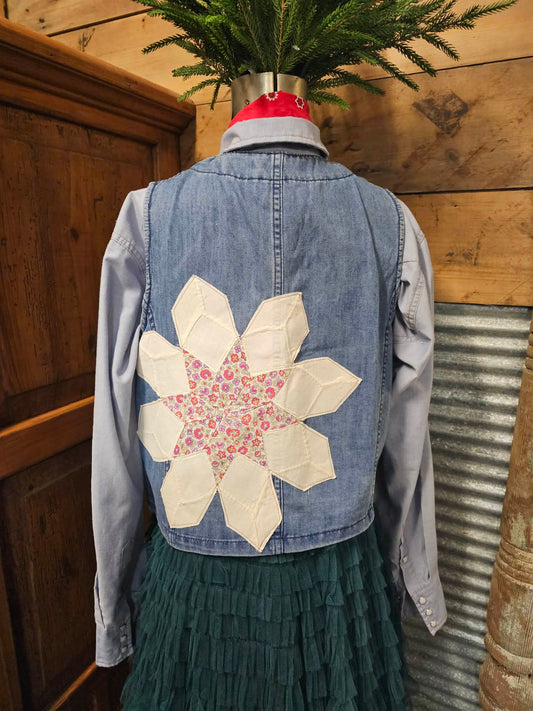 a denim vest with a quilted star on the back in a rustic setting