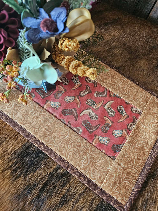 Quilted toilet topper shown with a floral arrangement.